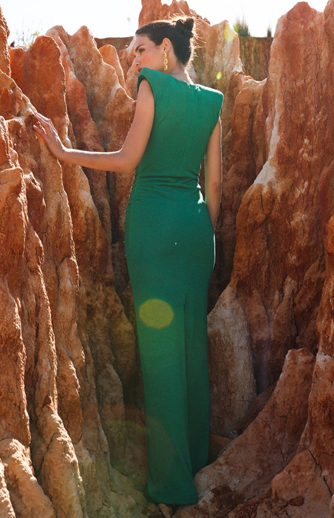 Long, narrow, Lurex knit dress with V-shaped neckline, with rhombus detail in the center and draped. With shoulder pads marked in green.